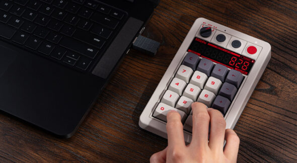 8BitDo Retro 18 N Edition mechanical numpad with seven-segment LED calculator display lit on a dark desk
