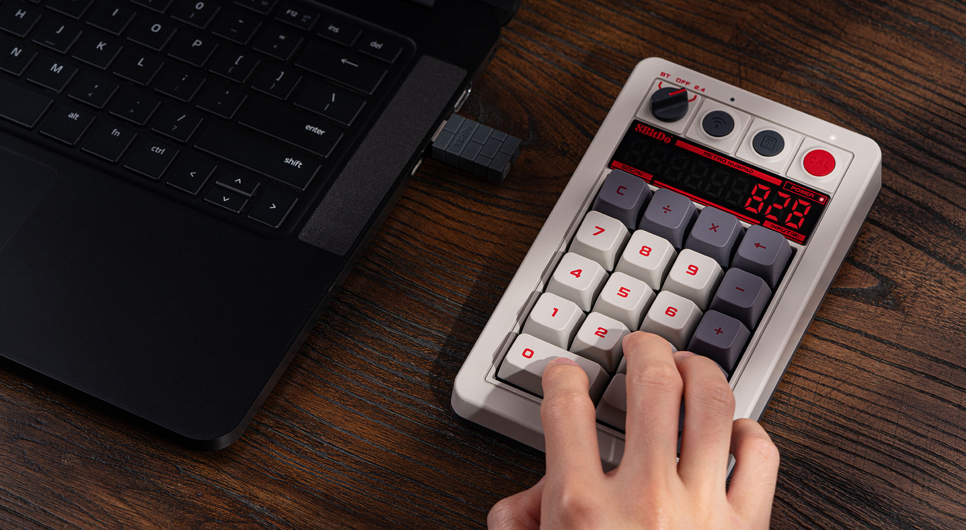 8BitDo Retro 18 N Edition mechanical numpad with seven-segment LED calculator display lit on a dark desk