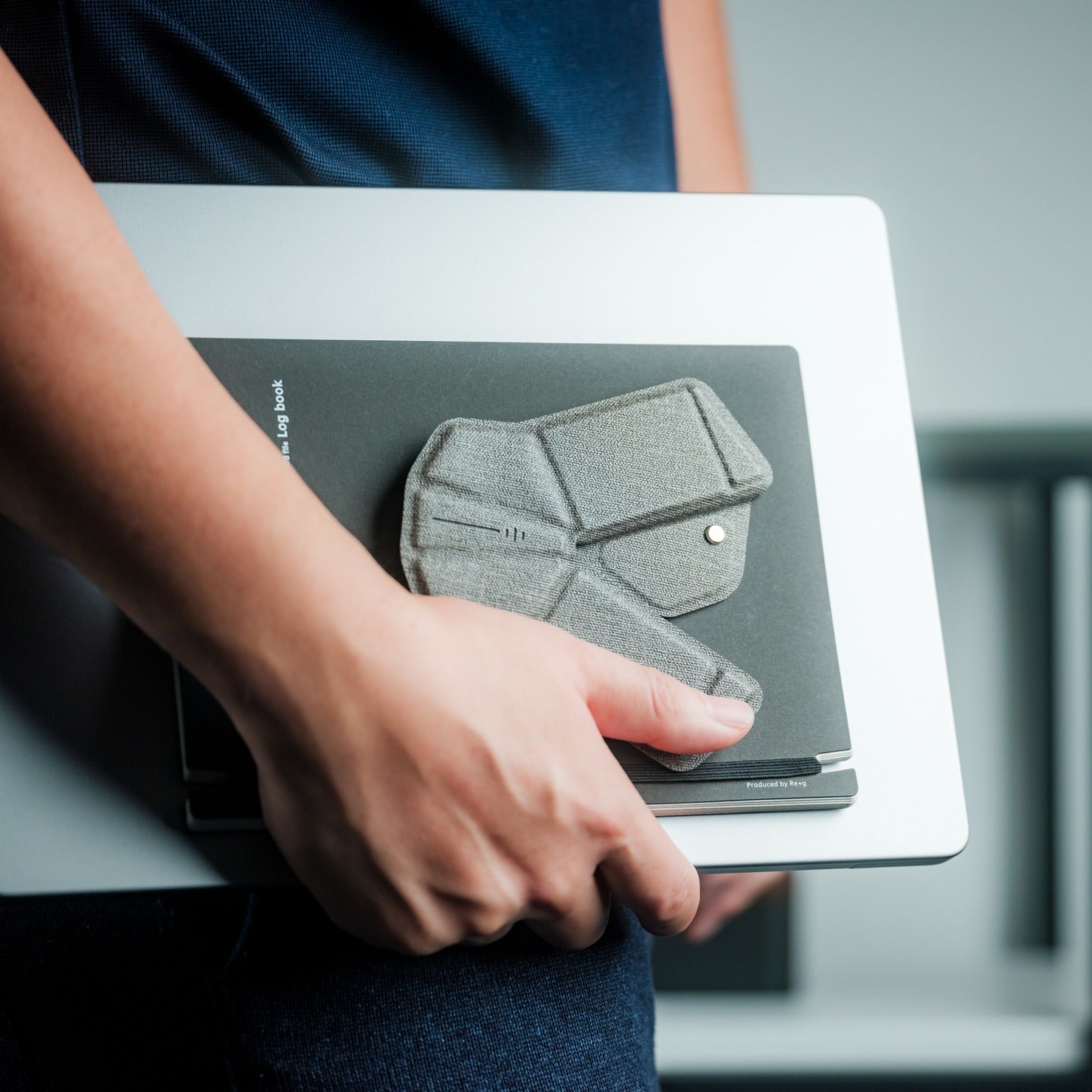 OrigamiSwift folded flat on a notebook carried with a laptop