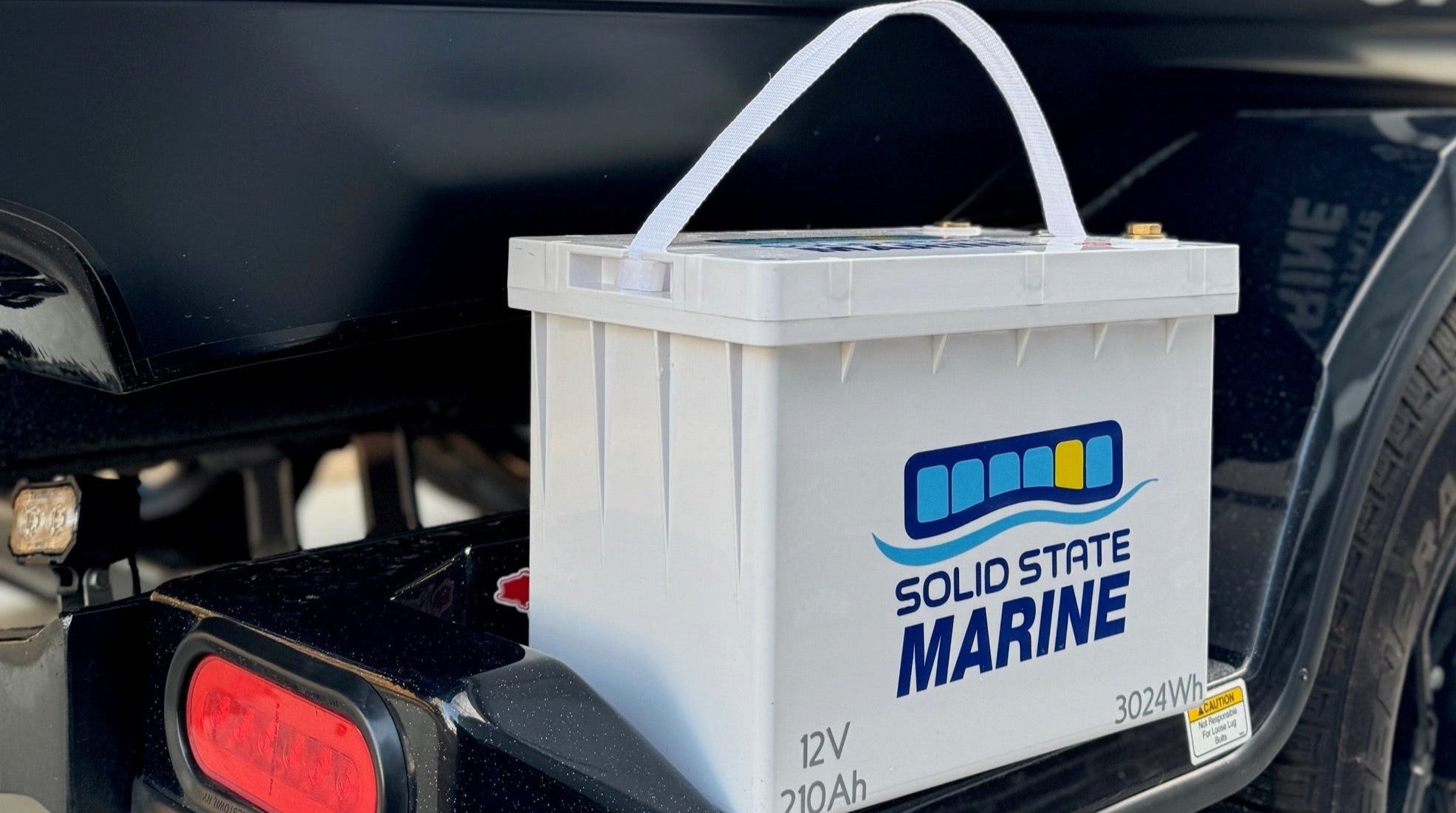 Solid State Marine battery with unique carry strap on boat trailer