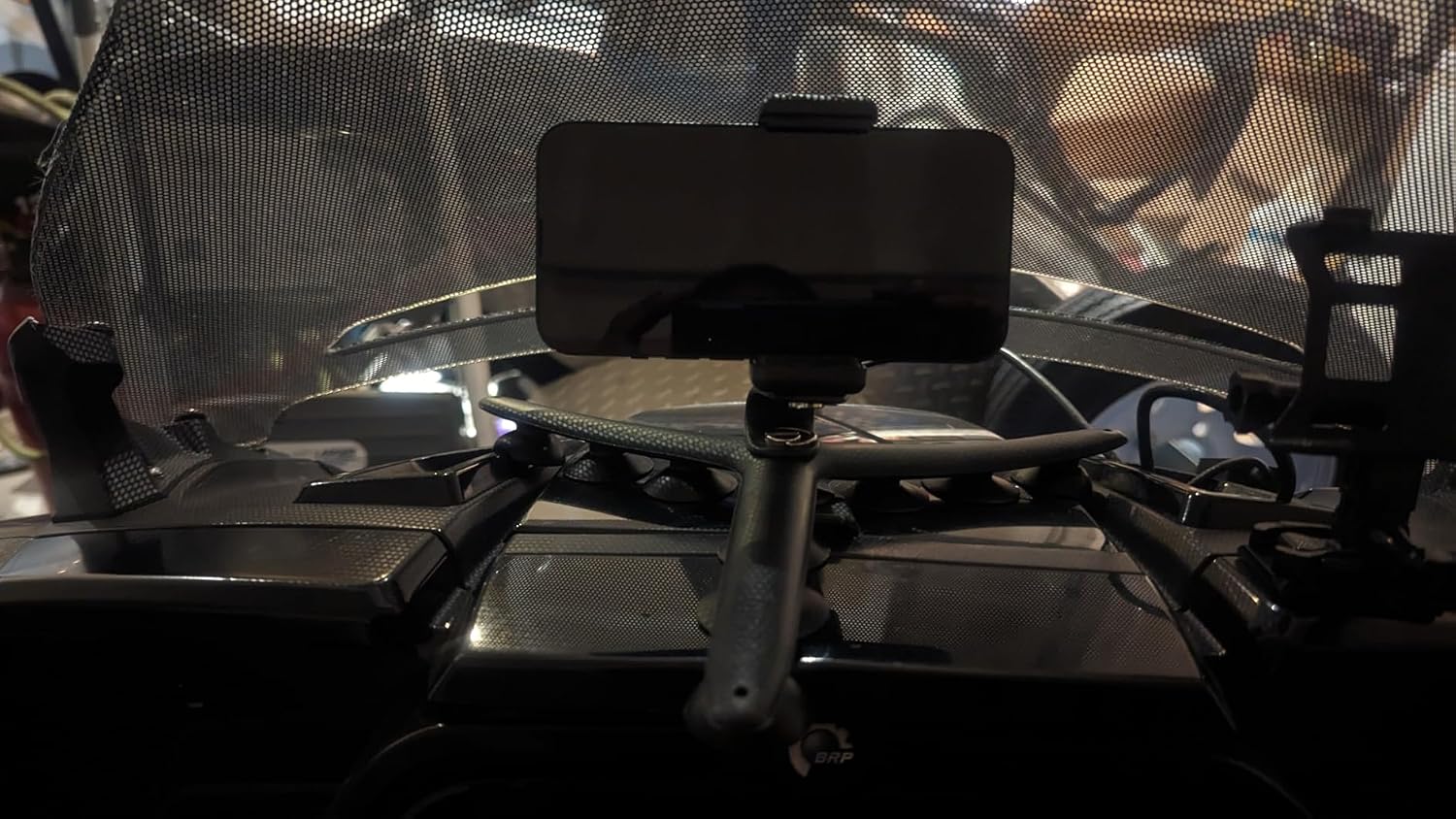 Black Tenikle 360 suctioned to an off-road vehicle dashboard holding a phone