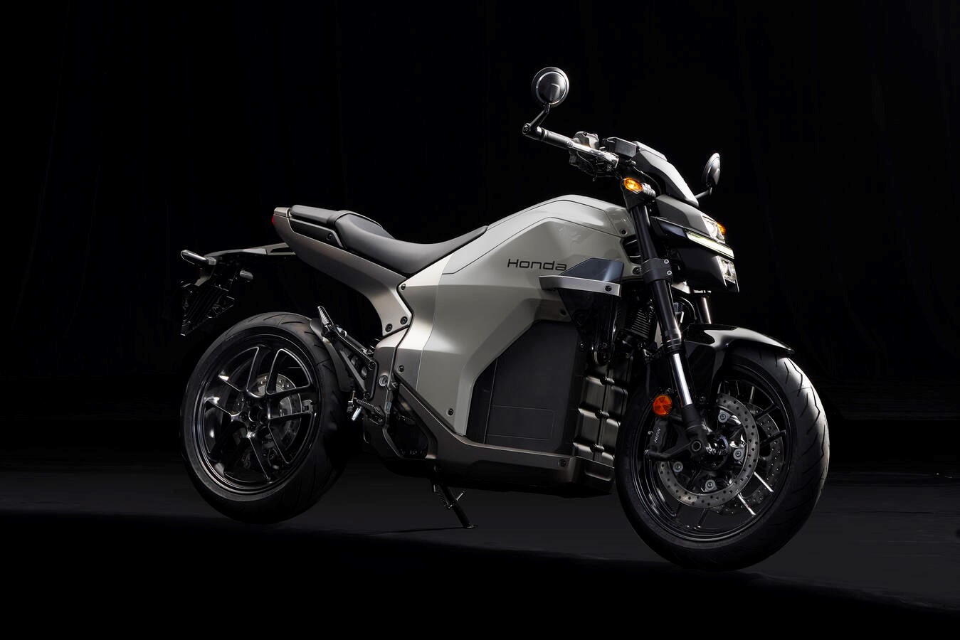 Honda WN7 electric motorcycle in silver gray on a dark studio background