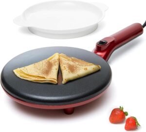 Moss and Stone red electric crepe maker with a folded crepe on its nonstick plate next to a white batter tray