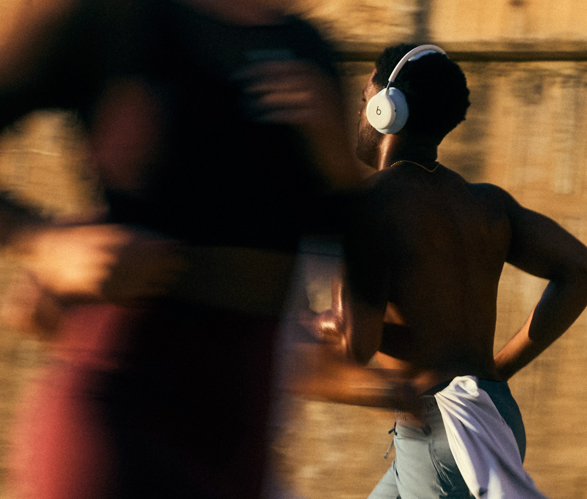Runner wearing Beats 360 headphones on a city street