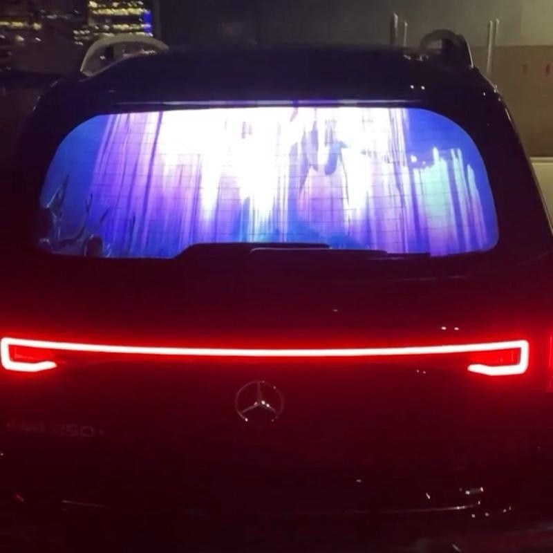 Pranos HoloGlass back windshield display glowing on an SUV at night