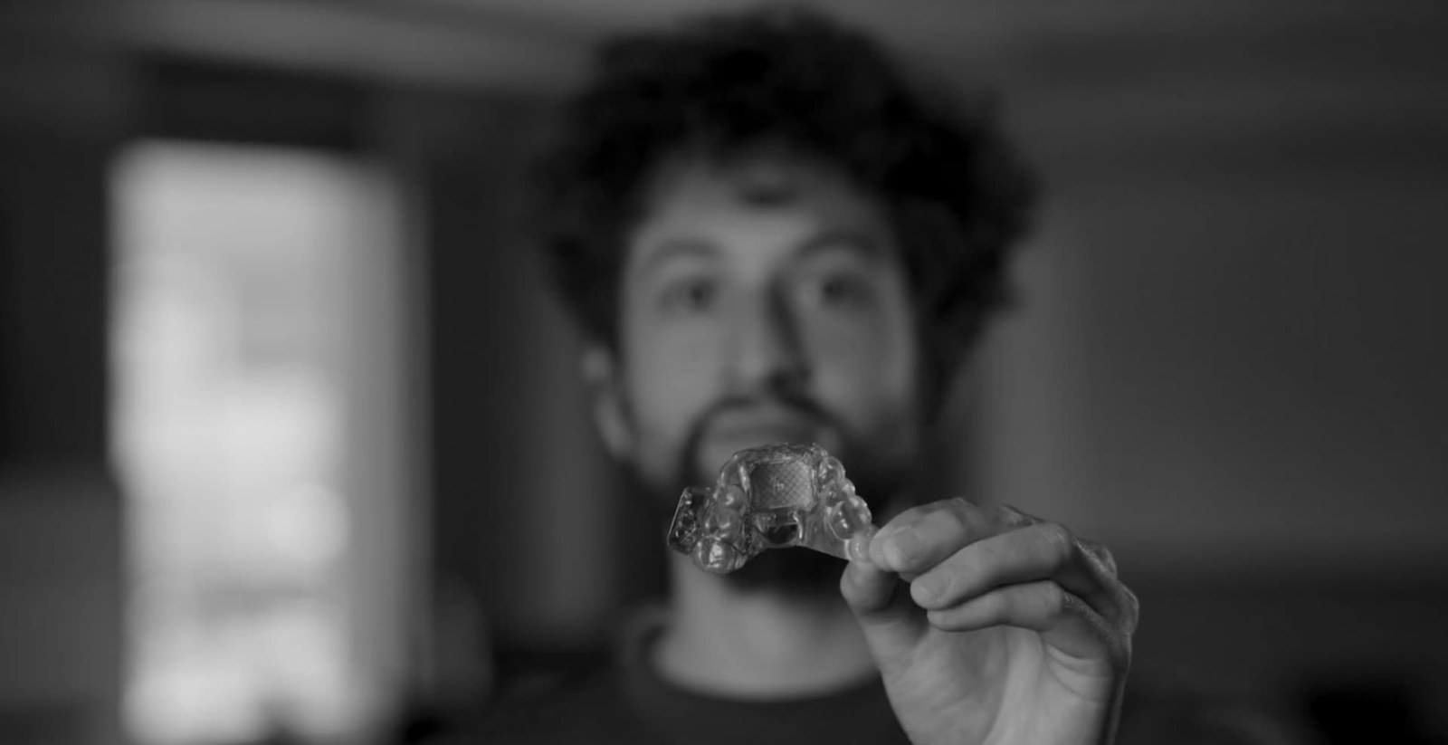 Man holding a MouthPad up to the camera