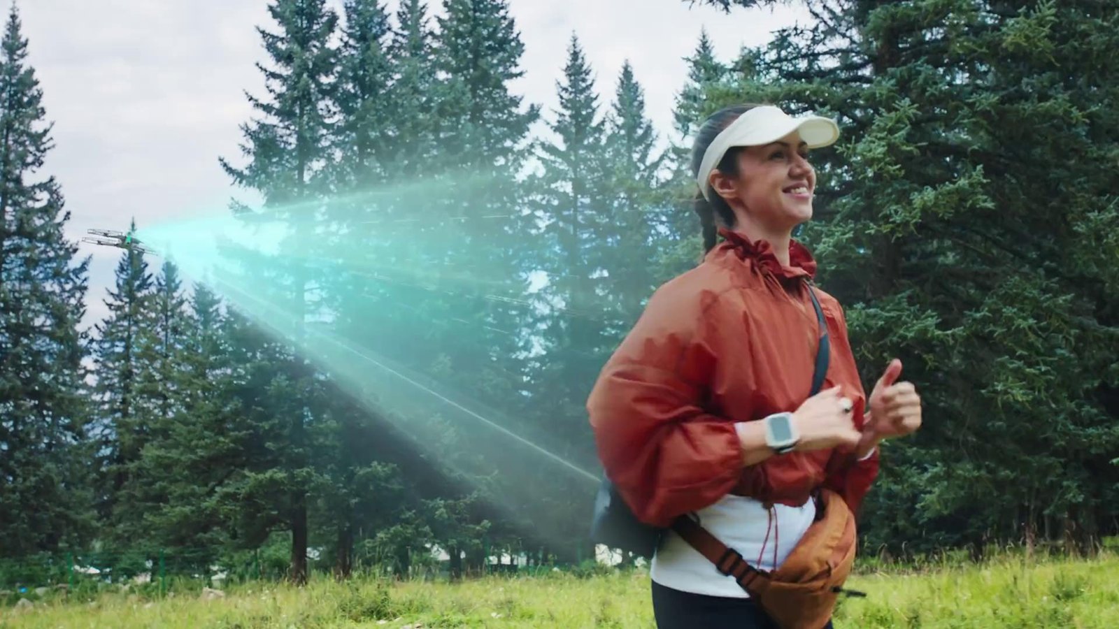 Hiker wearing the Antigravity Watch Remote as the A1 drone tracks her through a forest