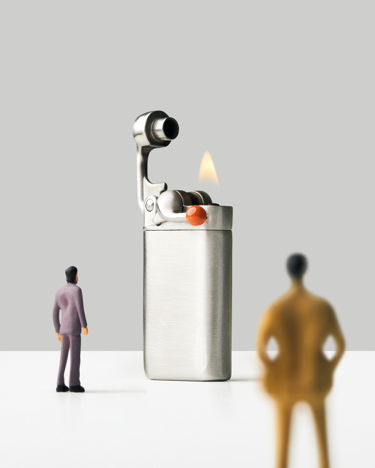 Craighill Swingtop lighter lit with its swingarm open next to tiny figurines for scale