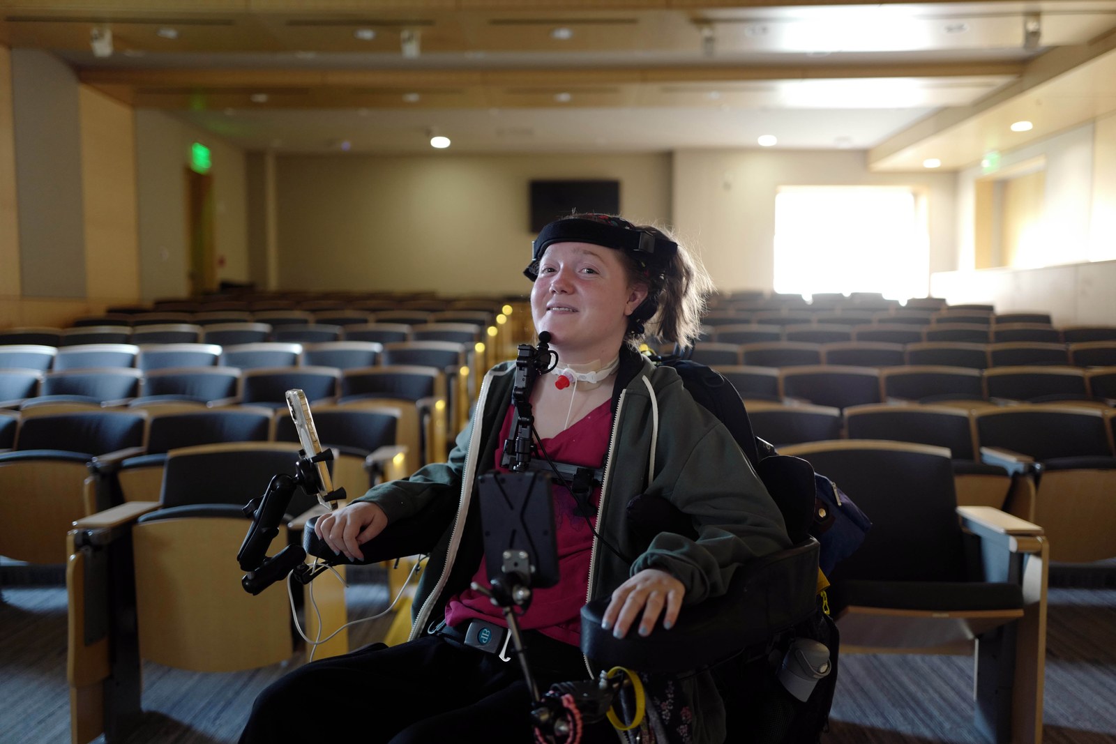 MouthPad user in a power wheelchair inside a lecture hall