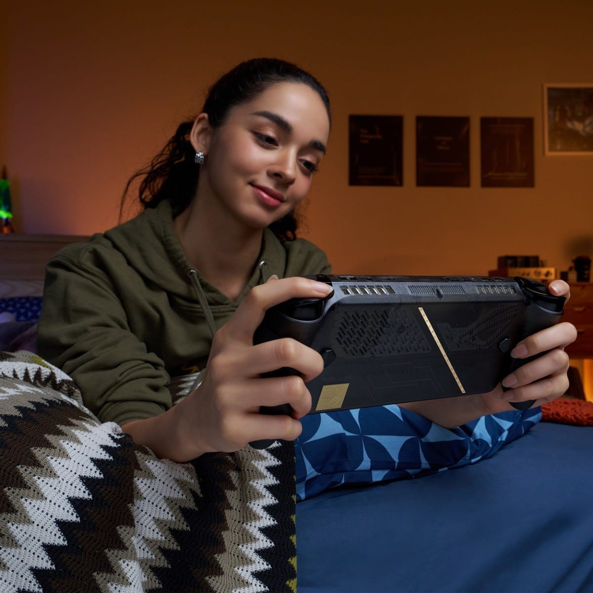 Woman playing the ROG Xbox Ally X20 on a couch