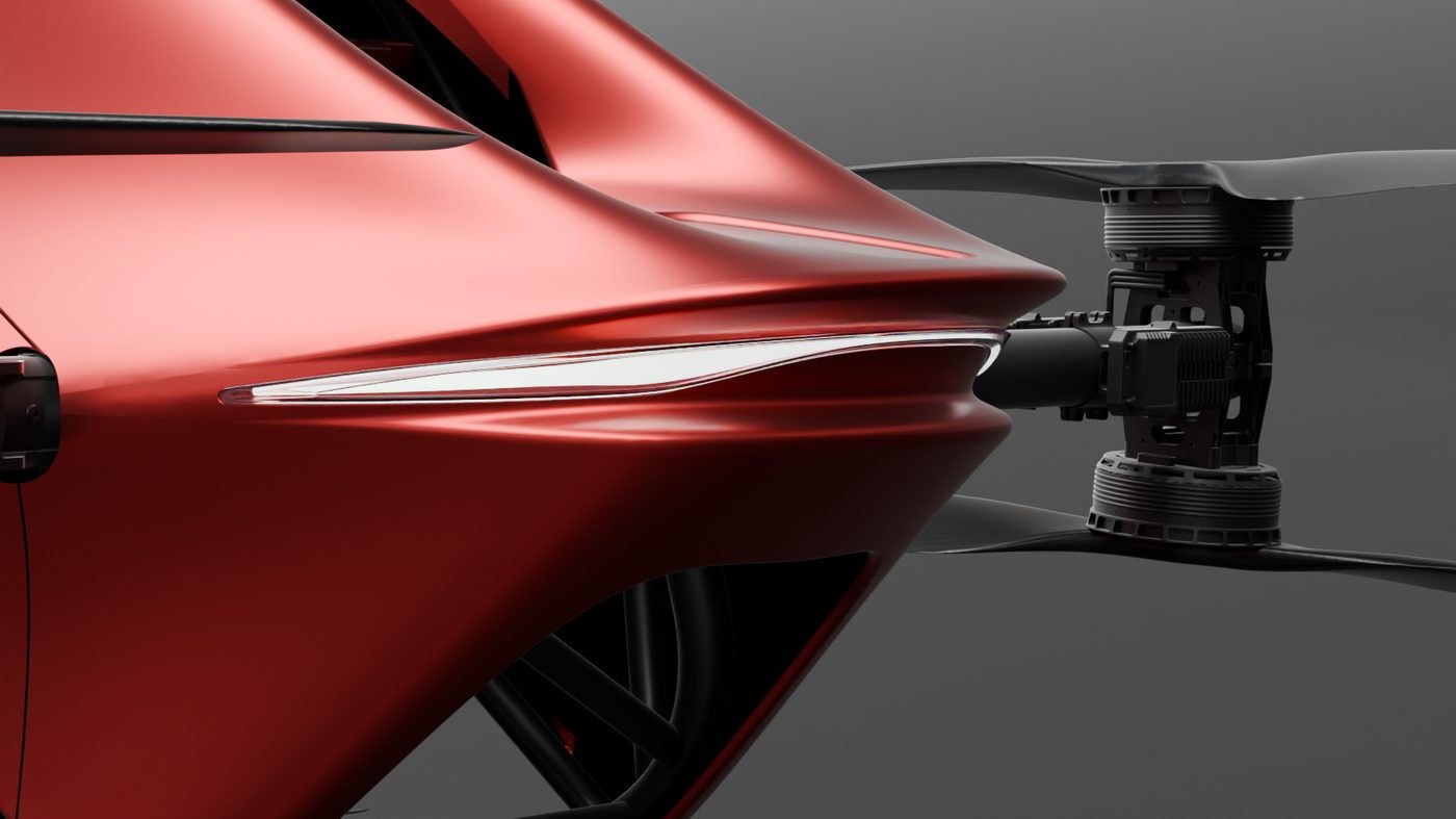 Detail of a YIVTOL S-Zero rotor motor and propeller mounted on an arm beside the red carbon body