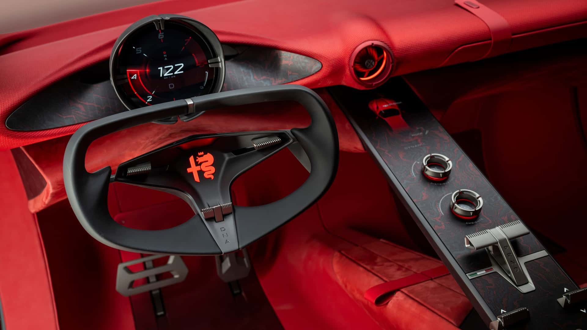 Round cannocchiale digital binnacle and open-top yoke-style steering wheel inside the Alfa Romeo Cuorerosso