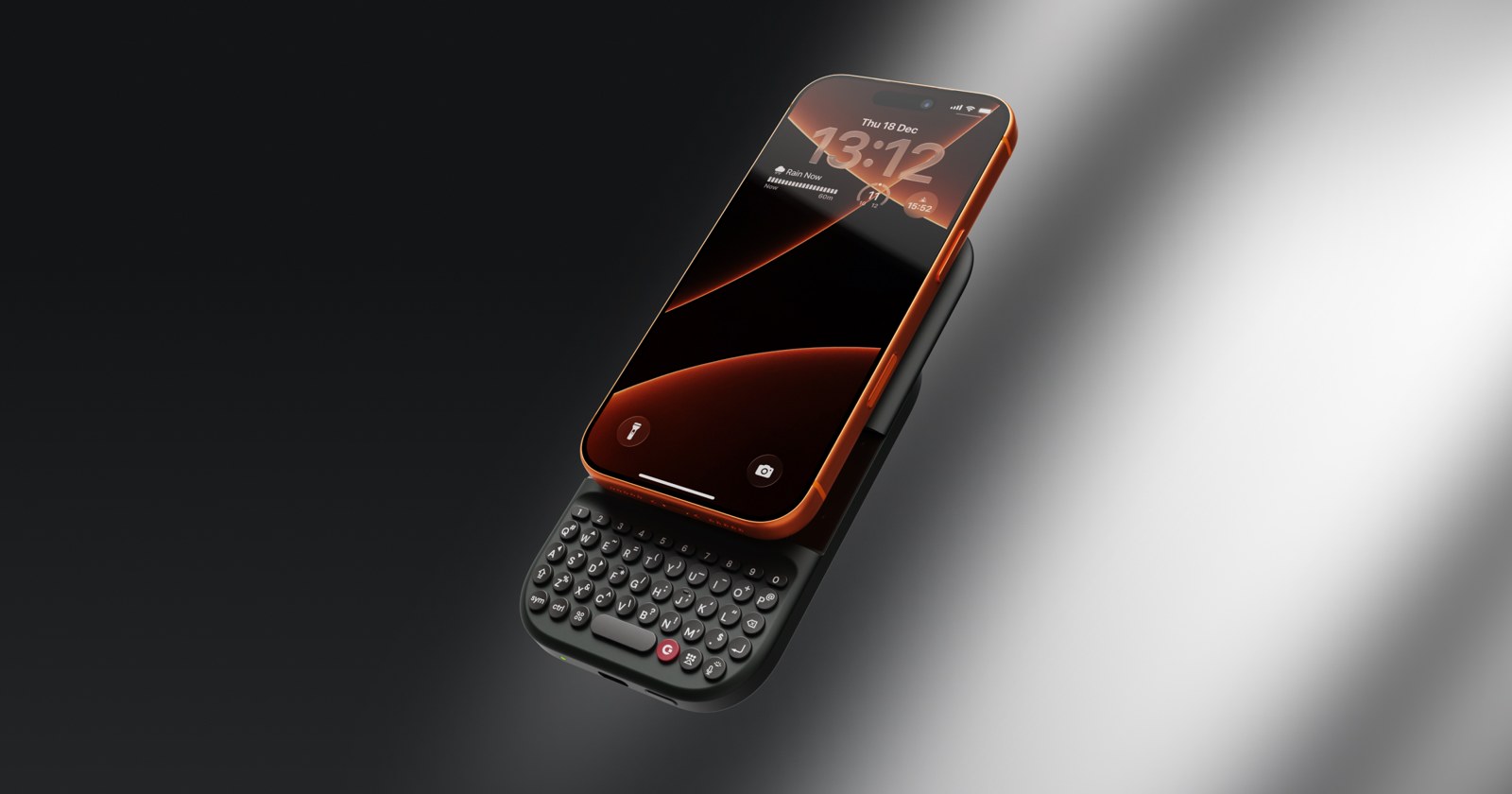 Clicks Power Keyboard with keys extended under a phone, angled view