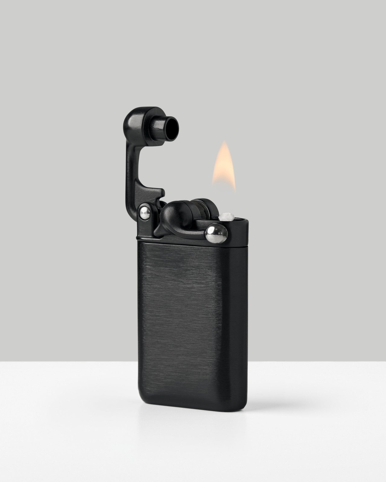 Black finish Craighill Swingtop lighter with the top open and lit