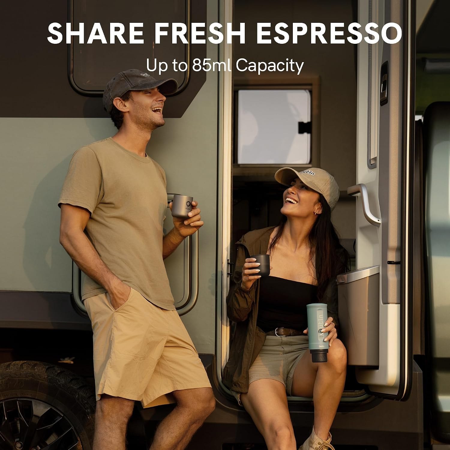 Couple drinking espresso from an OutIn Nano 2 outside an RV