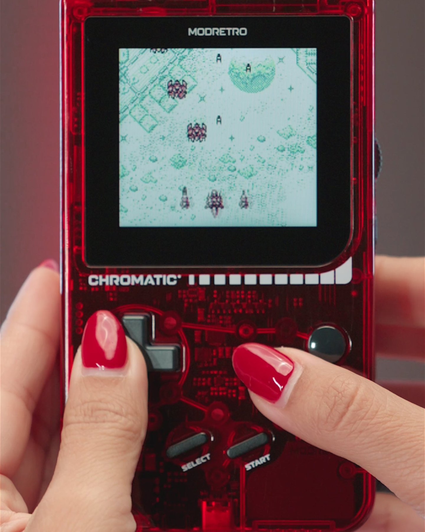 Hands playing a game on a red Chromatic Transparent