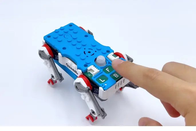 Finger pressing Quaddle top buttons for Learn and Replay teach mode